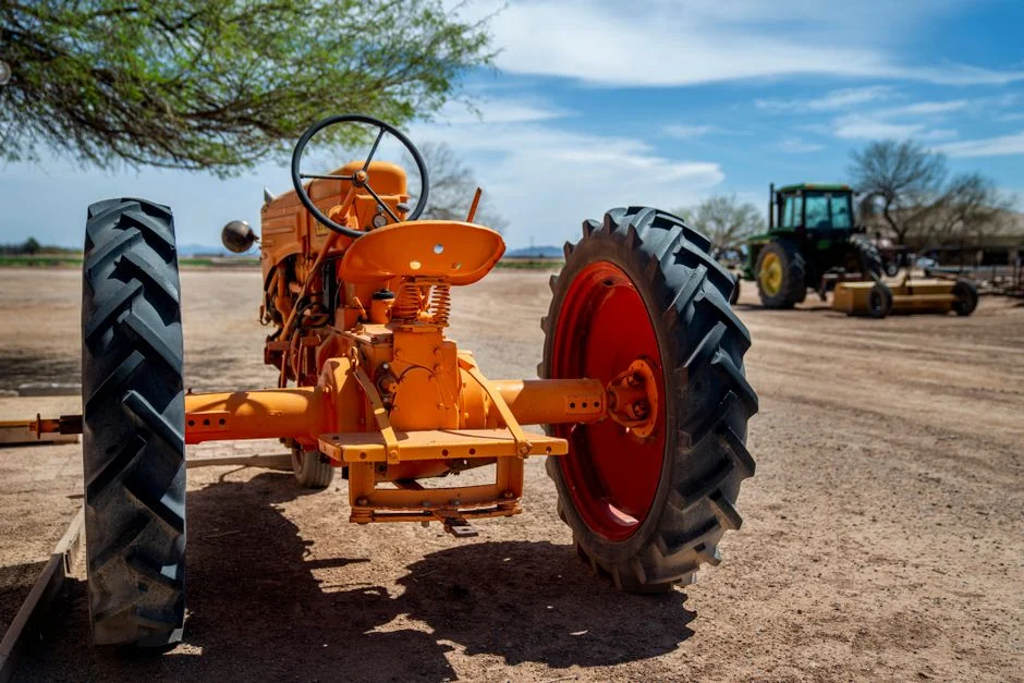 Orange vintage tractor on a rural farm, highlighting machinery and agriculture