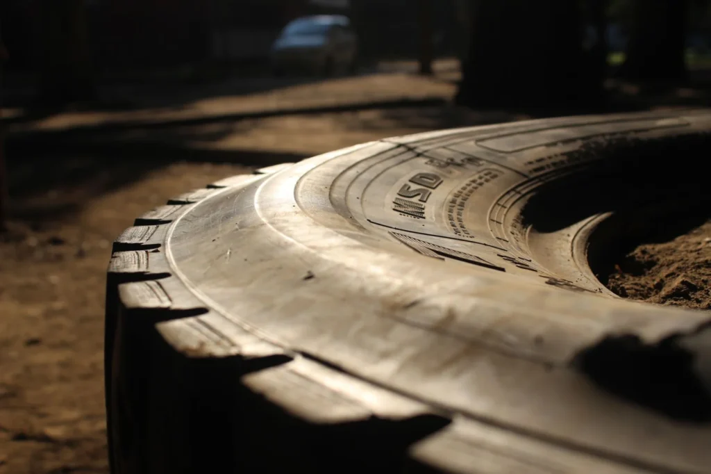 Vintage tractor tire in warm sunlight on a dirt road