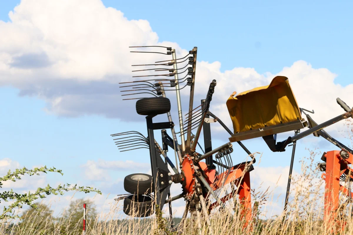 Firestone Tractor Tire Size Chart: Every Size by Model Detailed view of farm machinery in a field against a bright blue sky with fluffy clouds.