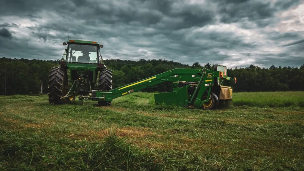 R3 Tires: What They Are, Where They Work and When They Don't Green tractor mowing grass under a stormy sky