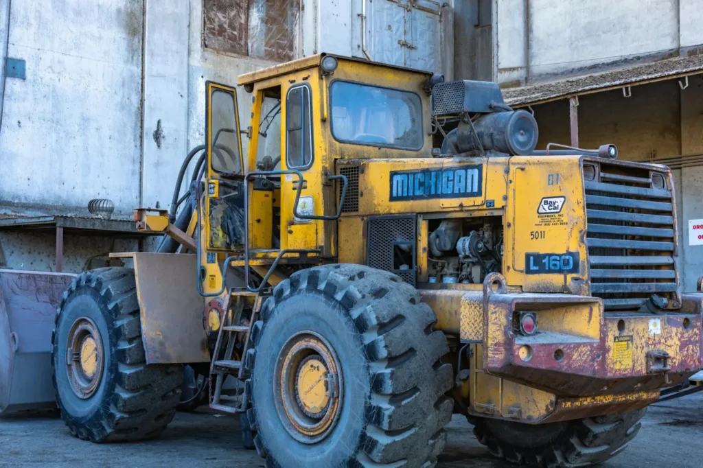 Large industrial loader parked outdoors near a warehouse