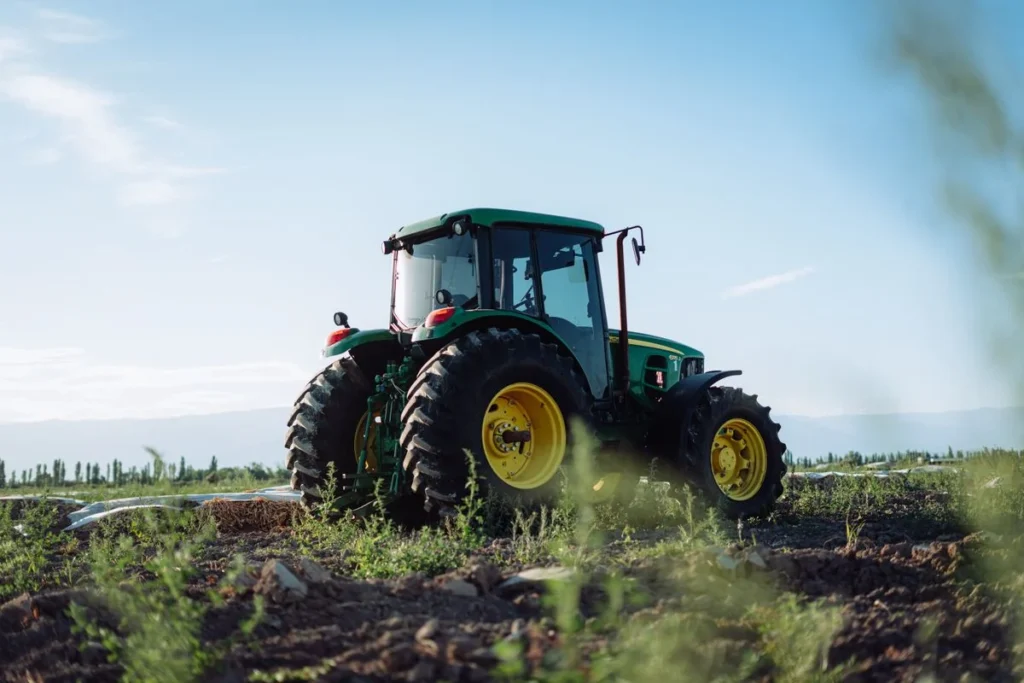 Tractor Tire Size Guide: How to Read Every Number on the Sidewall Front-wheel-assist tractor with smaller front and larger rear tires in a field