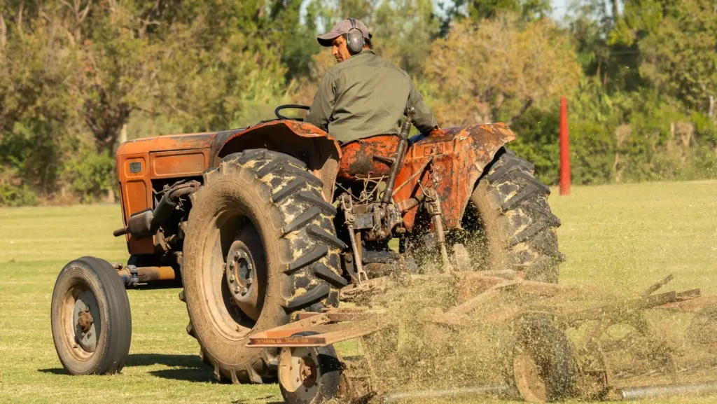 R3 Tires: What They Are, Where They Work and When They Don't Farmer driving an old tractor while mowing a grass field