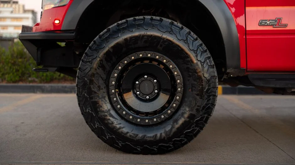 Rugged off-road tread on a pickup truck tire parked outdoors