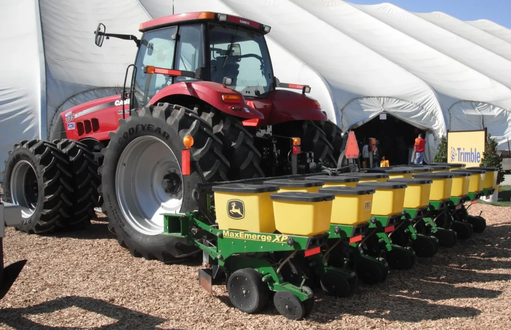 Case IH tractor hitched to a John Deere row-crop planter