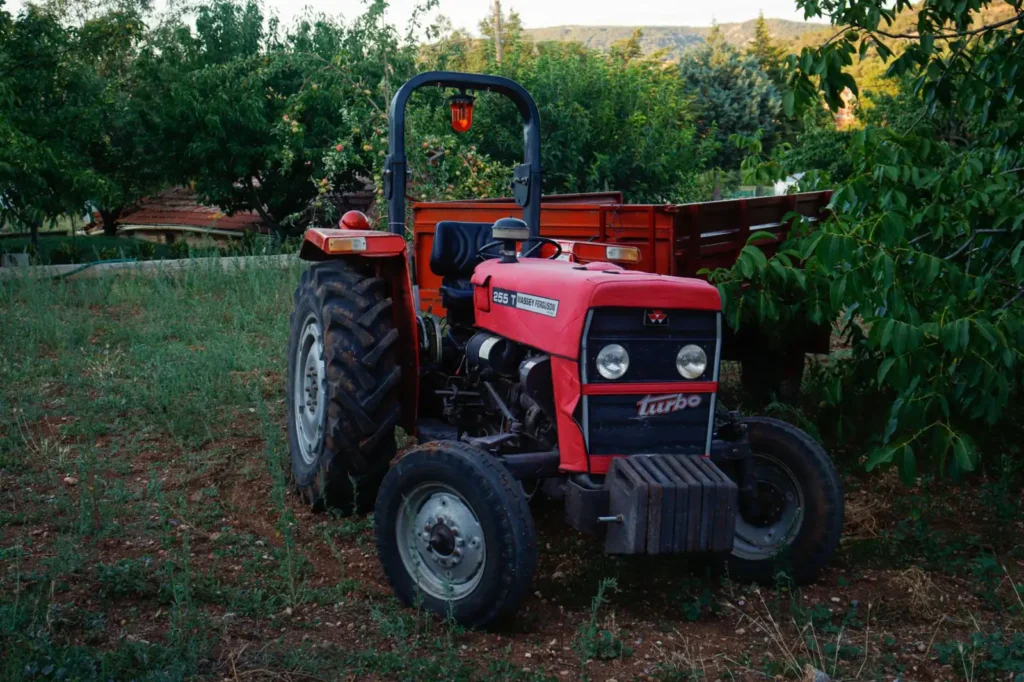 Red tractor parked in a green field