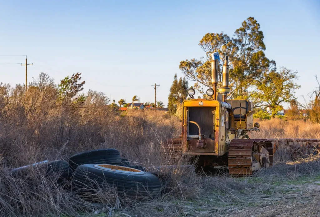 DOT Tractor Tires: How to Read the Date Code and Tire Age Rusty abandoned tractor in a field with discarded tires