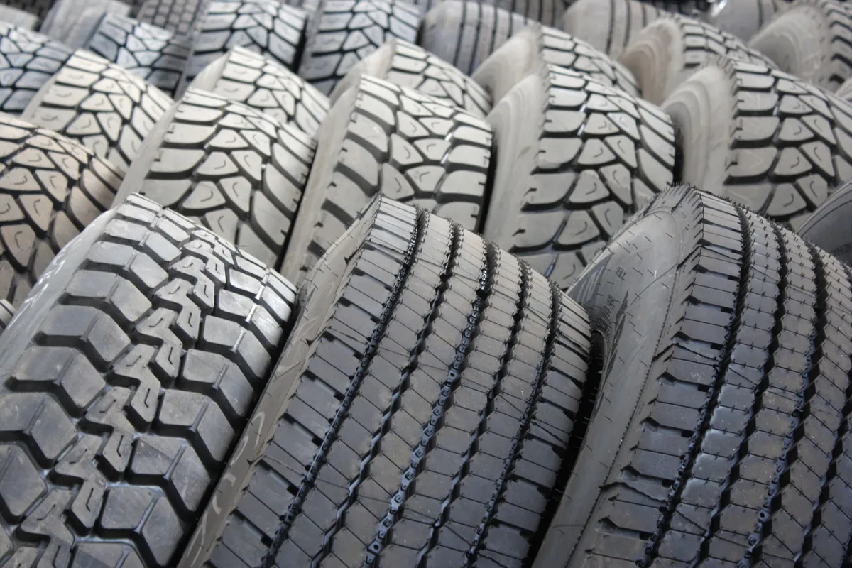 Front Tractor Tires: Which Tread, Size and Pair to Buy High-quality image of stacked industrial tires showcasing tread patterns.