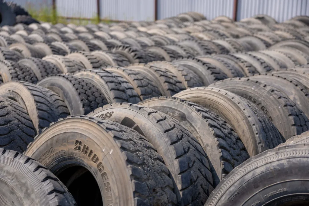 DOT Tractor Tires: How to Read the Date Code and Tire Age Stacked used tires in an outdoor storage yard