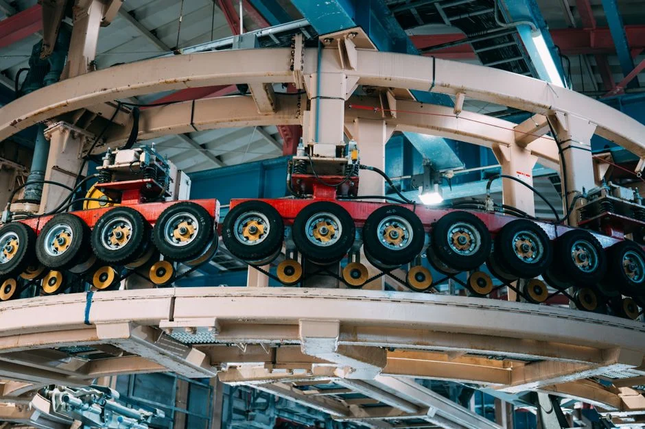 Close-up view of a complex industrial conveyor system inside a manufacturing facility