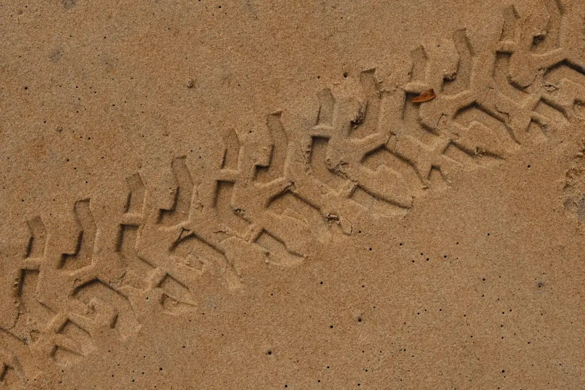 Firestone Tractor Tire Size Chart: Every Size by Model Close-up of tire tracks indented in sandy ground, showcasing pattern and texture.