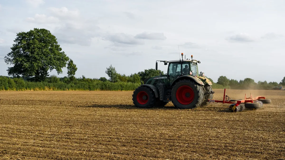 A tractor preparing agricultural land during autumn in Wiershop, Germany.