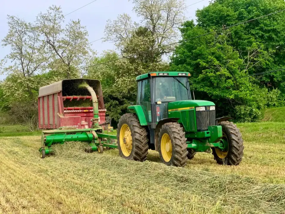 Tractor Tire Size Guide: How to Read Every Number on the Sidewall Tractor pulling a forage wagon across a hay field