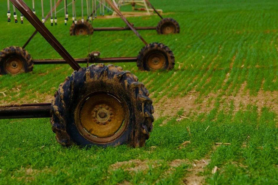 Close-up of irrigation system wheels on a green farm field