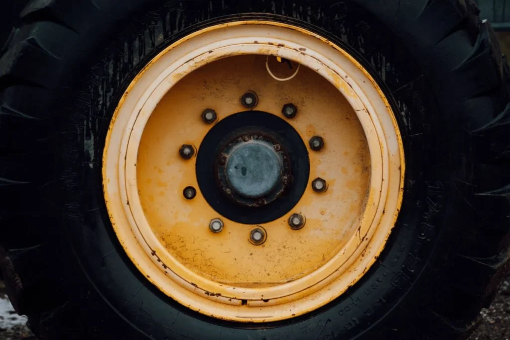Tractor Tire Size Guide: How to Read Every Number on the Sidewall Close-up of a tractor tire mounted on a yellow rim