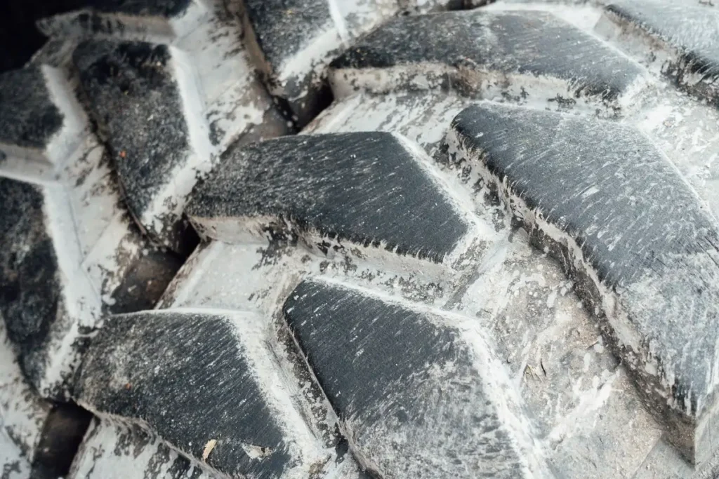 Tractor Tire Size Guide: How to Read Every Number on the Sidewall Close-up of tractor tire tread lugs with dried mud
