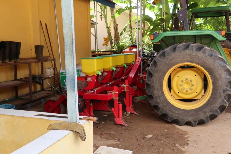 Tractor pulling a planter on a farm field