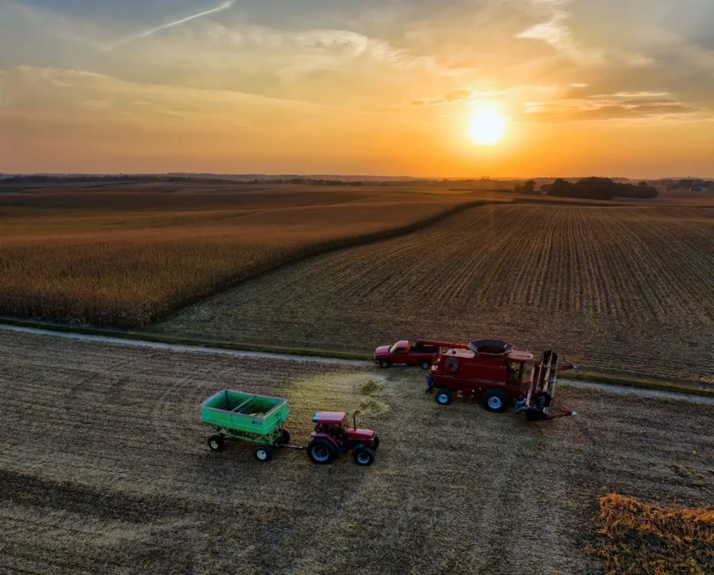 Trelleborg Tires: Who Owns Them, What They Make and Sizes We List Drone shot capturing tractors and combine harvester working on a farm in Minnesota at sunset. Picturesque agricultural scene.