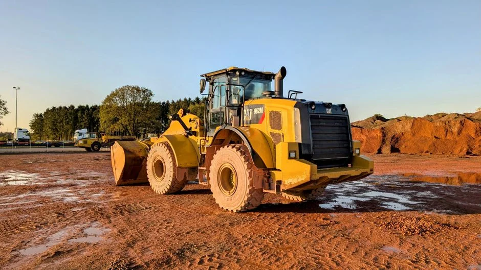 Large yellow wheel loader on a sandy construction site